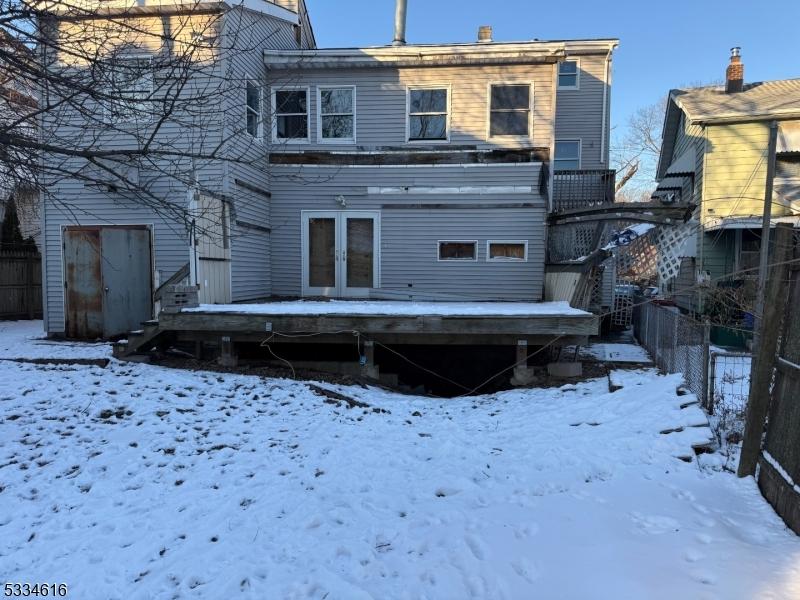 view of snow covered rear of property