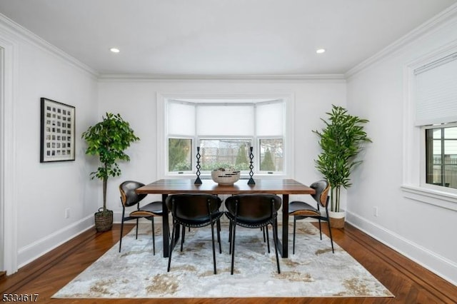 dining room featuring dark wood-type flooring and ornamental molding