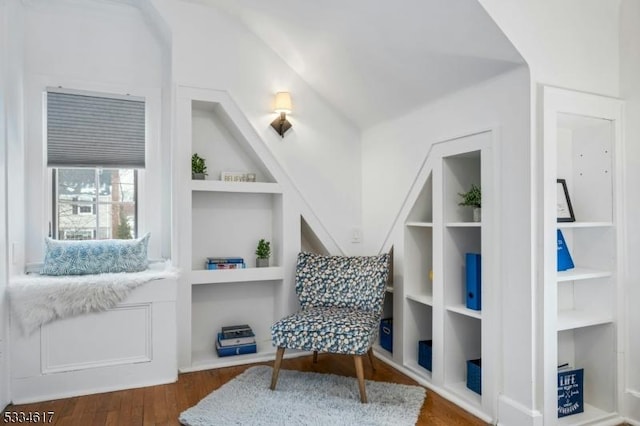 living area with dark wood-type flooring and built in features