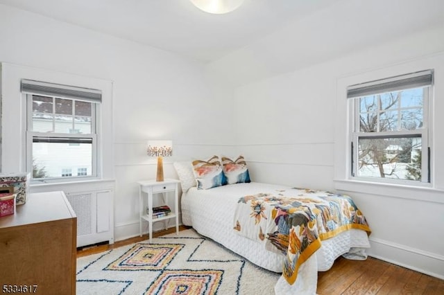 bedroom with radiator and light wood-type flooring