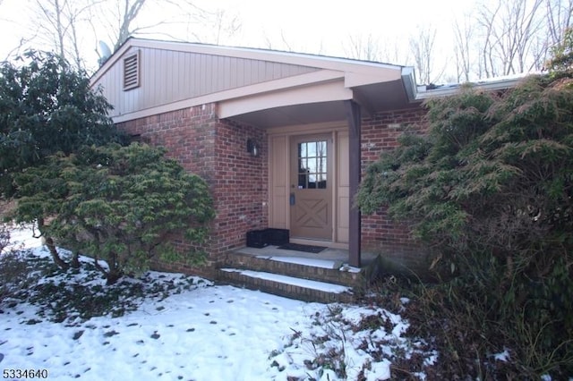 view of snow covered property entrance