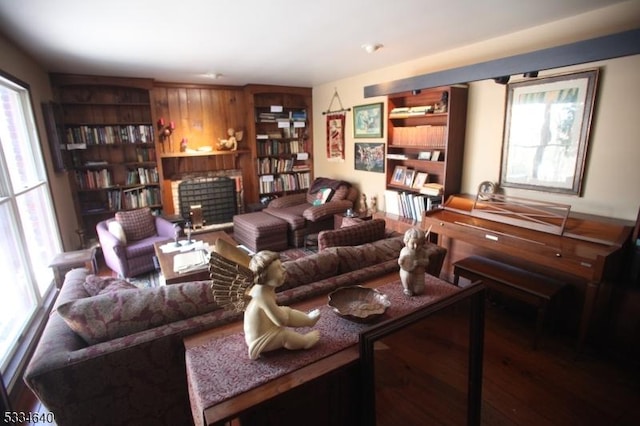 living room with hardwood / wood-style flooring and a brick fireplace