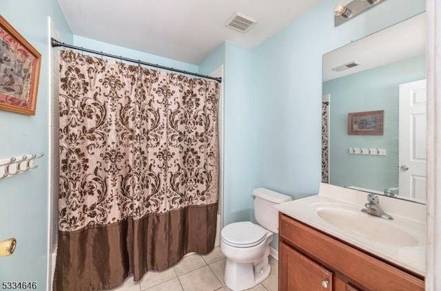 bathroom featuring tile patterned flooring, vanity, and toilet