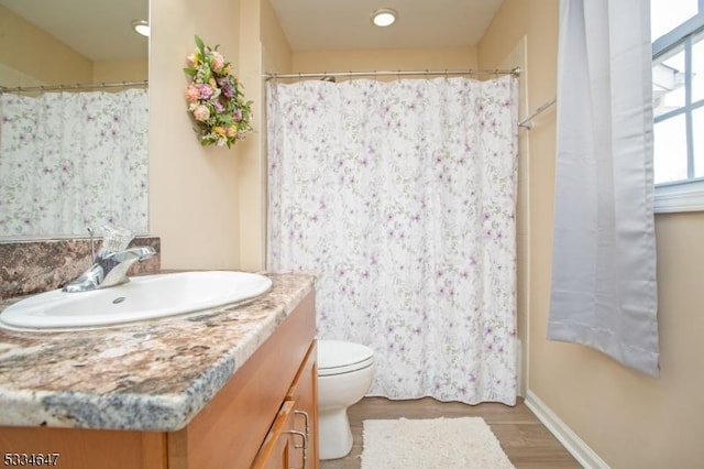 bathroom with vanity, hardwood / wood-style floors, and toilet