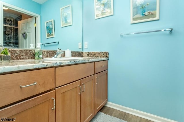 bathroom with vanity and hardwood / wood-style floors