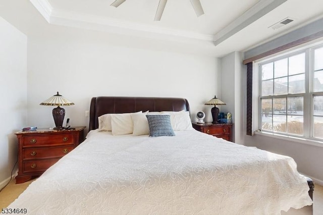 bedroom featuring crown molding, ceiling fan, and a tray ceiling