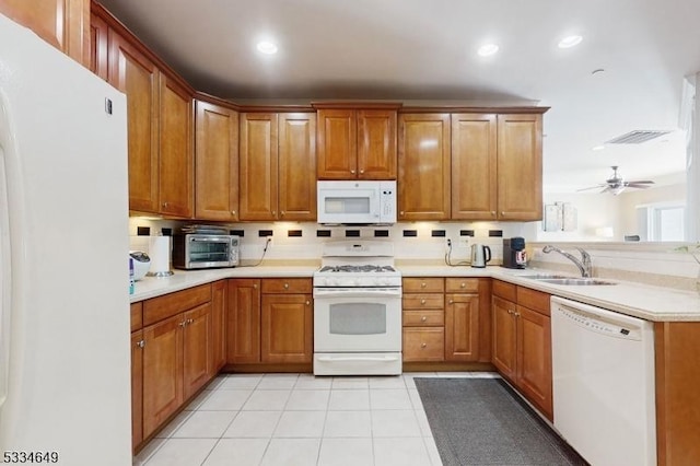 kitchen featuring sink, white appliances, ceiling fan, light tile patterned flooring, and kitchen peninsula