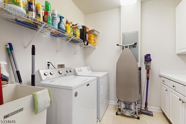 laundry area featuring sink, cabinets, light tile patterned floors, and independent washer and dryer