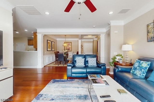 living room featuring ceiling fan, ornamental molding, dark hardwood / wood-style floors, and ornate columns