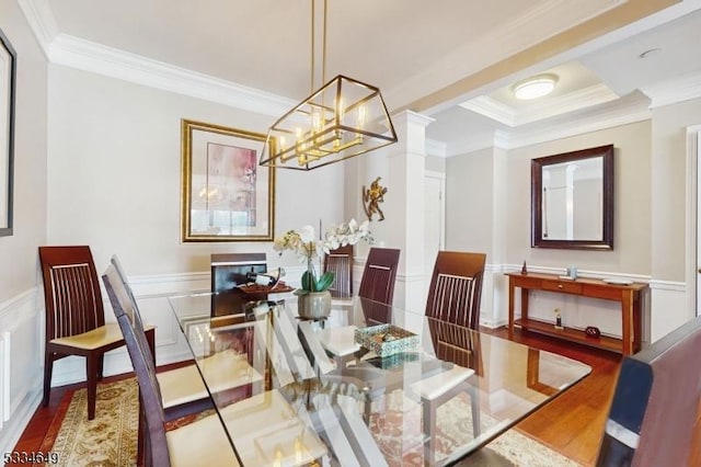 dining room featuring an inviting chandelier, wood-type flooring, and ornamental molding