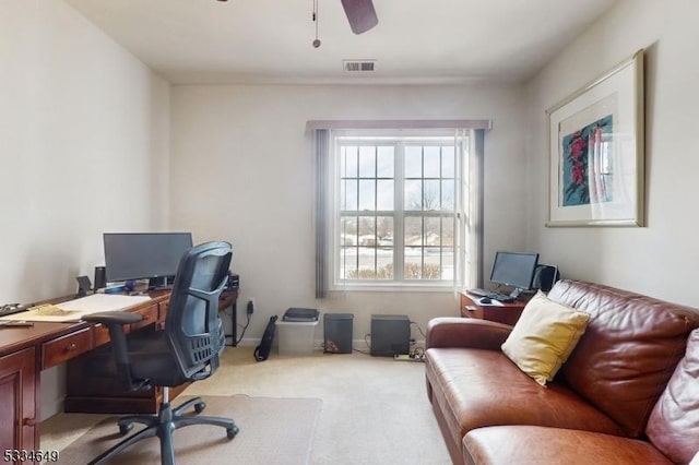 office featuring ceiling fan and light carpet