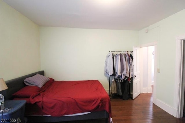 bedroom with dark hardwood / wood-style floors