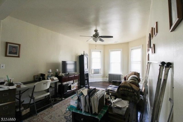 living room featuring radiator, wood-type flooring, and ceiling fan