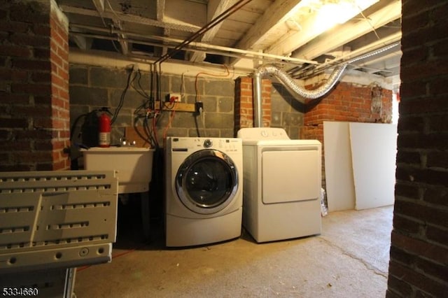 clothes washing area with separate washer and dryer