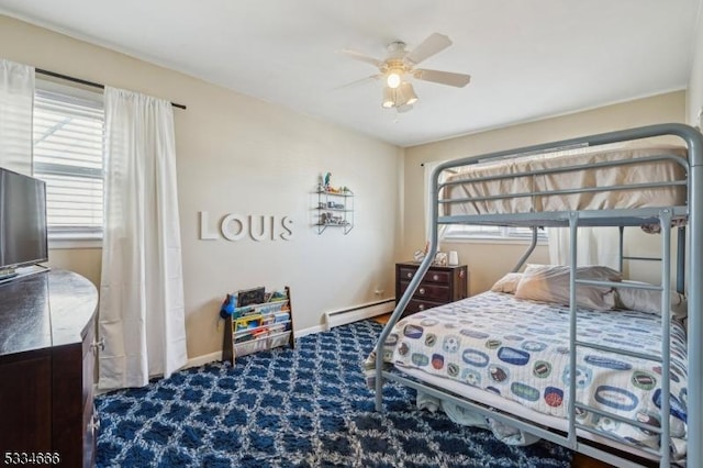 carpeted bedroom with ceiling fan, multiple windows, and a baseboard heating unit