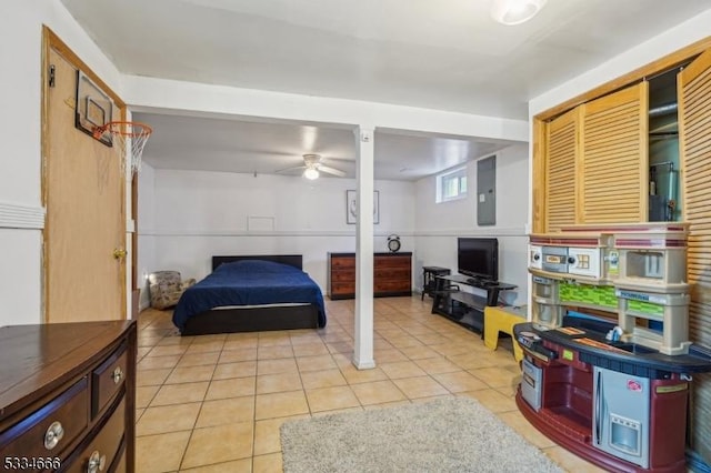 tiled bedroom with electric panel and a closet