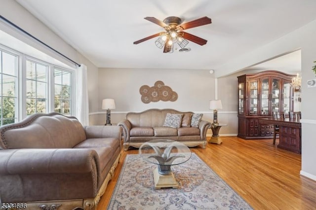 living room with hardwood / wood-style flooring and ceiling fan