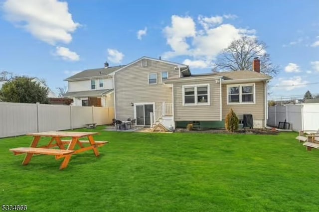 rear view of property featuring a lawn