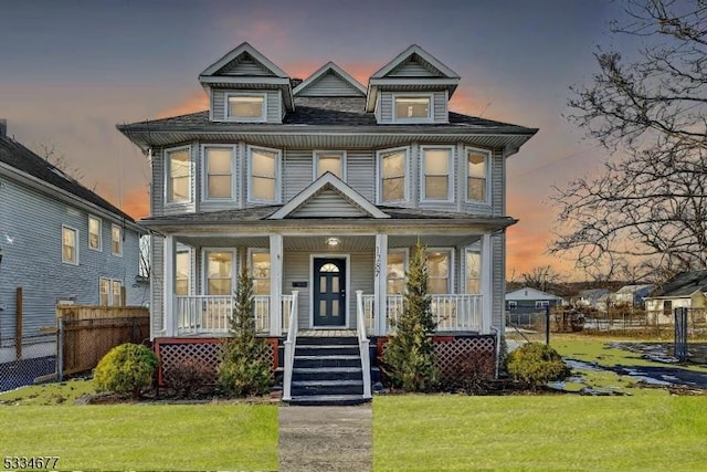 view of front of home featuring a yard and covered porch