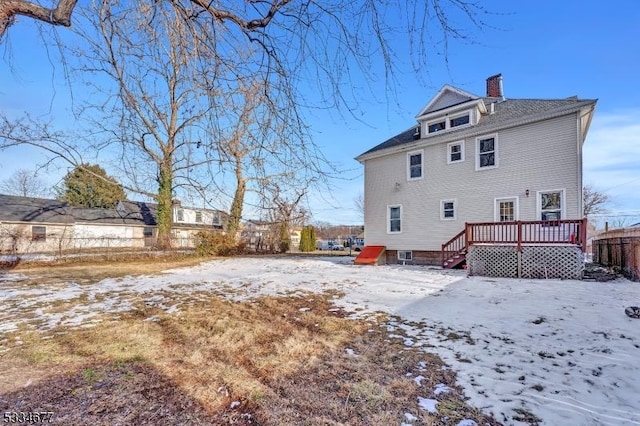 snow covered property featuring a deck