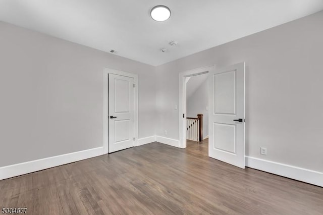 spare room with dark hardwood / wood-style floors