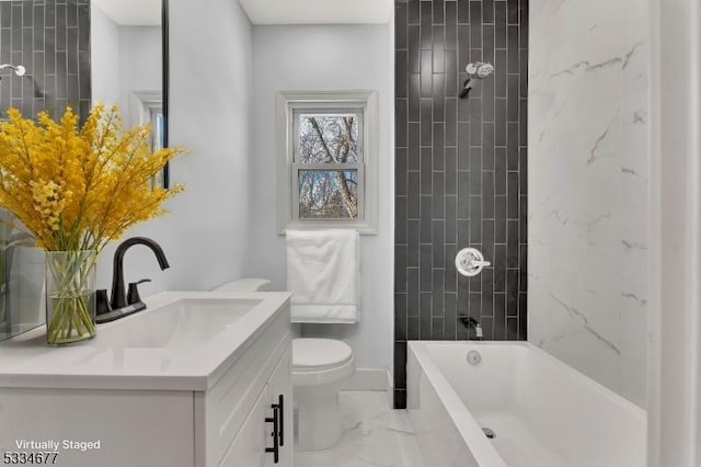 full bathroom featuring vanity, tiled shower / bath combo, and toilet