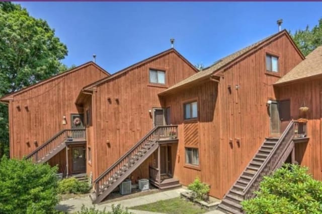 rear view of house featuring central AC