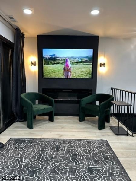 home theater room featuring hardwood / wood-style flooring