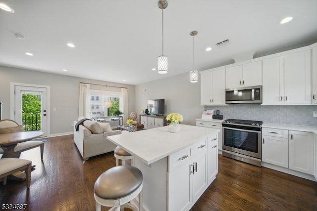 24 Stonybrook Cir, Fairfield Twp, NJ 07004 - kitchen featuring stainless steel appliances, recessed lighting, dark wood-style floors, a center island, and tasteful backsplash