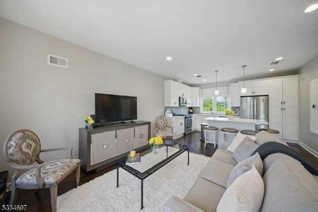 24 Stonybrook Cir, Fairfield Twp, NJ 07004 - living room with dark wood-type flooring and recessed lighting