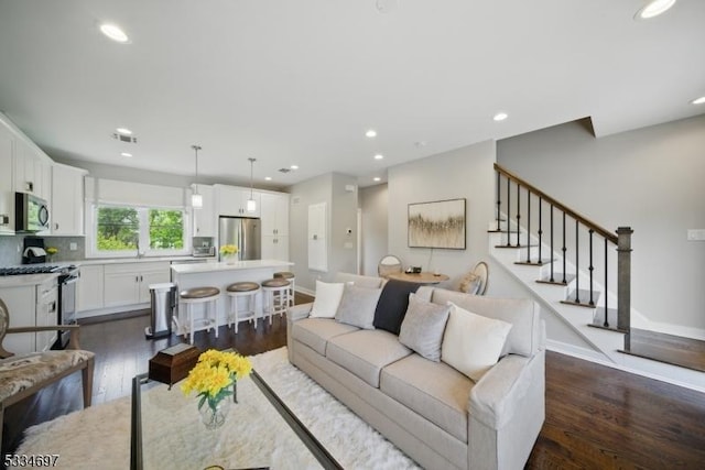 24 Stonybrook Cir, Fairfield Twp, NJ 07004 - living room with dark wood-type flooring, recessed lighting, baseboards, and stairs