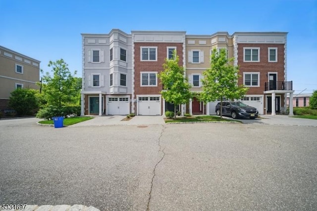 24 Stonybrook Cir, Fairfield Twp, NJ 07004 - view of property with driveway and an attached garage