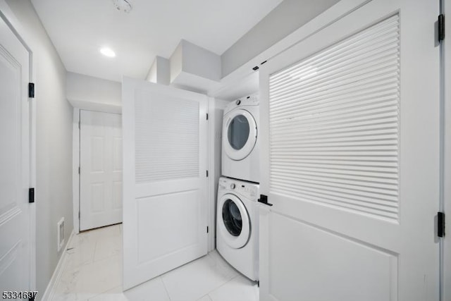 24 Stonybrook Cir, Fairfield Twp, NJ 07004 - laundry room with stacked washer / drying machine, light marble finish floors, baseboards, and recessed lighting