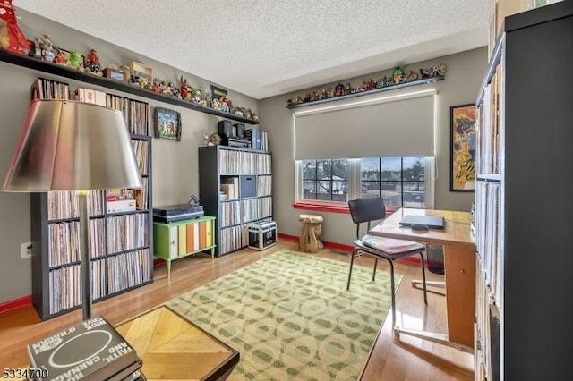 home office featuring hardwood / wood-style floors and a textured ceiling