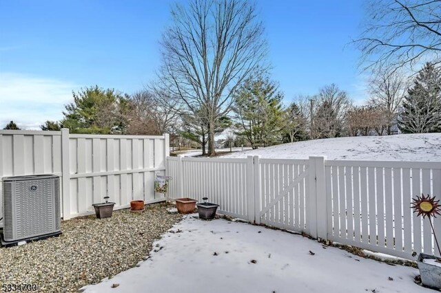 snowy yard featuring cooling unit