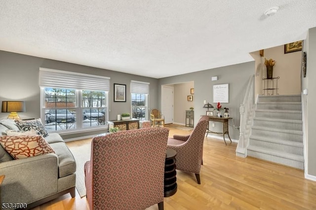 living room featuring a textured ceiling and light wood-type flooring