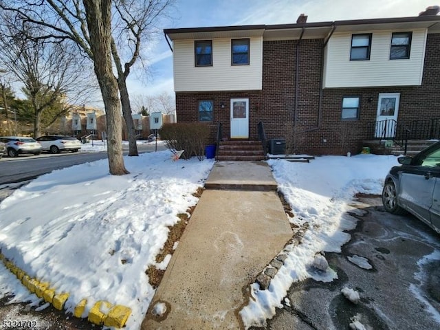 view of snow covered rear of property