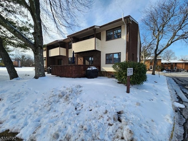 view of snow covered back of property