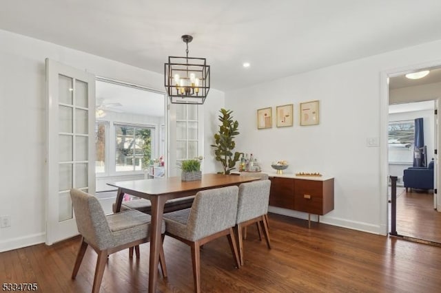 dining area featuring dark hardwood / wood-style floors and a chandelier