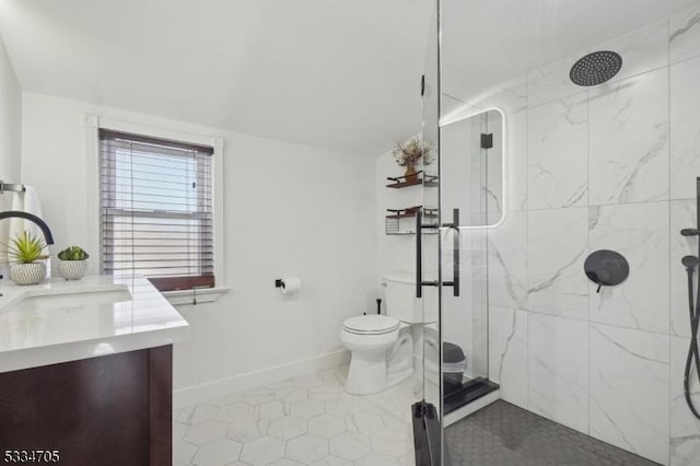 bathroom with vanity, toilet, and a shower with door