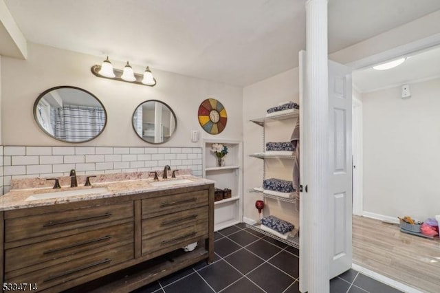 bathroom featuring tile patterned flooring, vanity, and backsplash