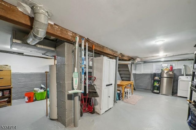 basement featuring washer / clothes dryer and stainless steel fridge