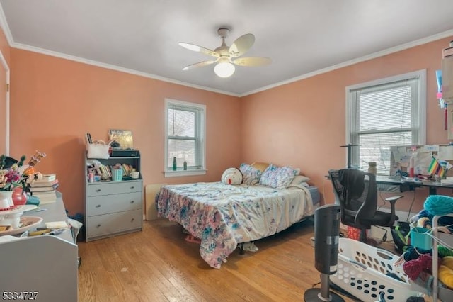 bedroom featuring crown molding, ceiling fan, and light wood-type flooring