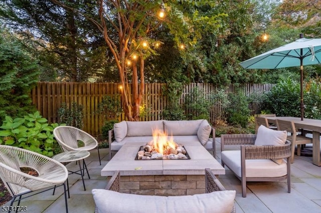 view of patio featuring an outdoor living space with a fire pit