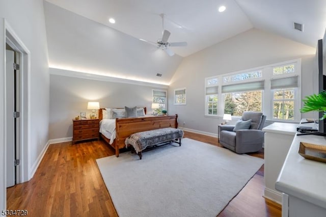 bedroom with ceiling fan, high vaulted ceiling, and hardwood / wood-style floors