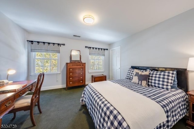 bedroom with dark colored carpet