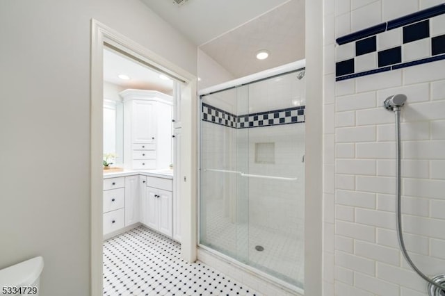 bathroom with vanity, toilet, and an enclosed shower