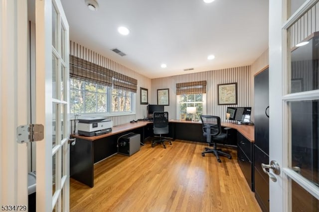 home office featuring french doors and light hardwood / wood-style flooring