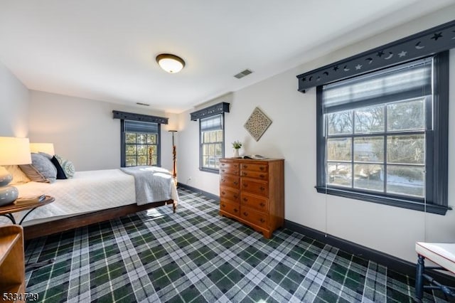 bedroom featuring dark colored carpet