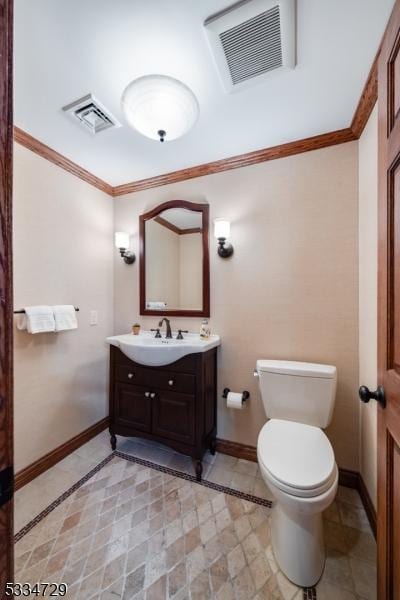 bathroom featuring crown molding, vanity, and toilet